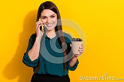 Photo of young cheerful woman communication say tell mobile drink latte caffeine isolated over yellow color background Stock Photo