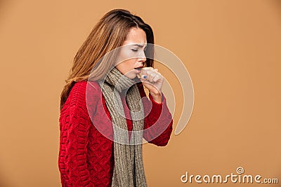 Photo of young coughing brunette woman in warm wear Stock Photo