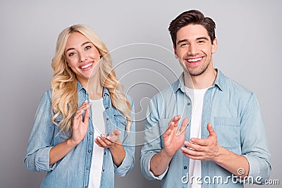 Photo of young couple happy positive smile applauding hands celebrate congrats success isolated over grey color Stock Photo