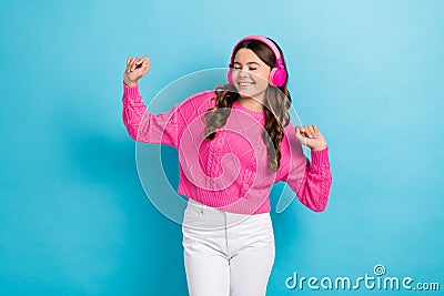 Photo of young dancing satisfied teenager schoolgirl wear new wireless pink headphones hands up active dance isolated on Stock Photo