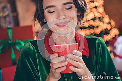 Photo of young dreamy charming positive santa helper woman hold mug rest coffee xmas inside house home Stock Photo