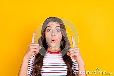 Photo of young excited girl look indicate fingers up advert direct way suggest advice over yellow color Stock Photo
