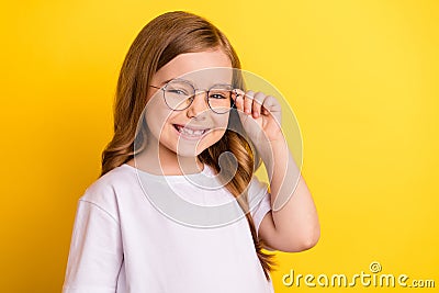 Photo of young excited small girl happy positive smile cheerful wear glasses isolated over yellow color background Stock Photo