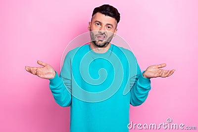 Photo of young funny grimace guy wear blue sweatshirt shrug shoulders dont know where money stolen cant help you Stock Photo