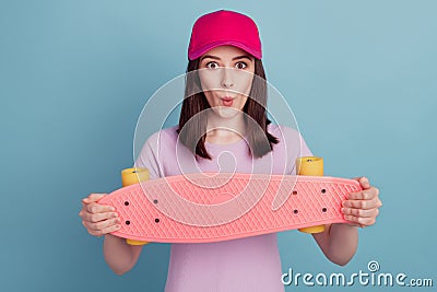 Photo of young girl excited skateboard rider headwear cool pouted lips isolated turquoise color background Stock Photo