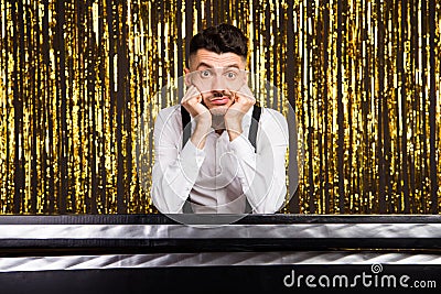 Photo of young handsome man unhappy sad hands touch cheeks bored party event isolated over glitter color background Stock Photo