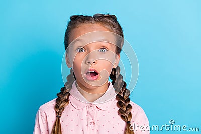 Photo of young little girl amazed shocked surprised stupor fake novelty news isolated over blue color background Stock Photo