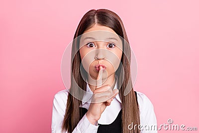 Photo of young little girl cover lips finger shh keep secret confidential shut up isolated over pink color background Stock Photo