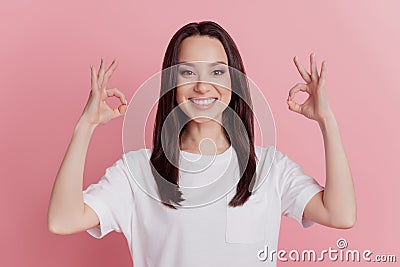 Photo of young lovely lady show okey symbol alright deal advertising great perfect isolated over pink color background Stock Photo