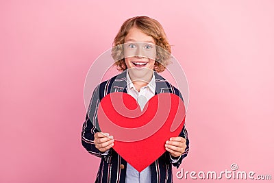 Photo of young school boy happy positive smile hold red heart cupid love card isolated over pastel color background Stock Photo