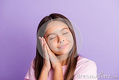 Photo of young schoolgirl happy smile enjoy rest relax sleep dream dreamy isolated over purple color background Stock Photo