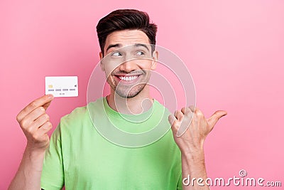 Photo young smiling happy man wear green t shirt indicate finger mockup default account user credit card isolated on Editorial Stock Photo