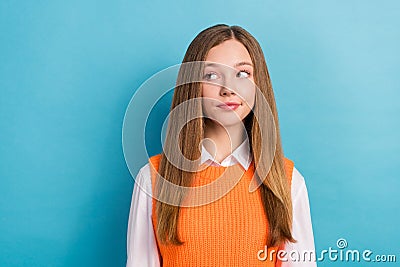 Photo of young suspicious minded creative teenage girl wear orange knitted jumper with shirt look empty space isolated Stock Photo