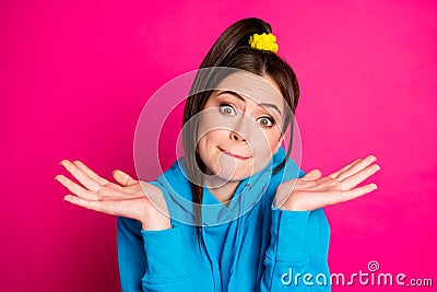 Photo of young uncertain unsure doubtful girl shrug shoulders don't know hesitant isolated on pink color background Stock Photo