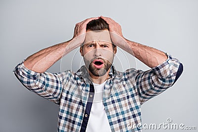 Photo of young unhappy upset stressed depressed amazed man hear shocking news isolated on grey color background Stock Photo