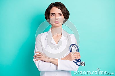 Photo of young woman serious crossed hands hold stethoscope therapist clinic illness isolated over teal color background Stock Photo