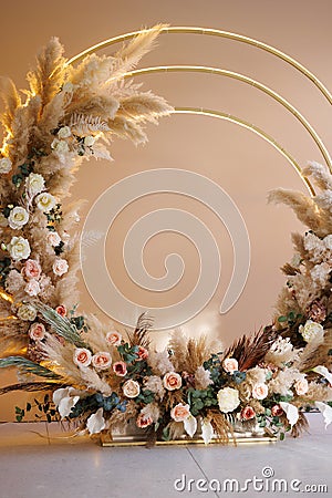 Photo zone in the form of a round portal decorated with flowers and pampas grass Stock Photo