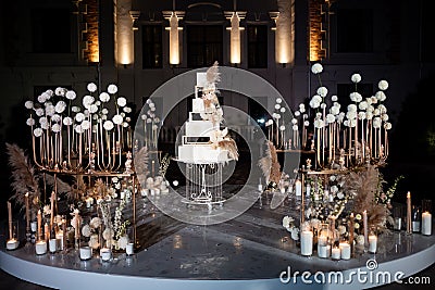 Photo zone, Unusual white tiered wedding cake. Stock Photo