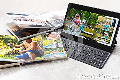 photobook album and tablet on the table Stock Photo