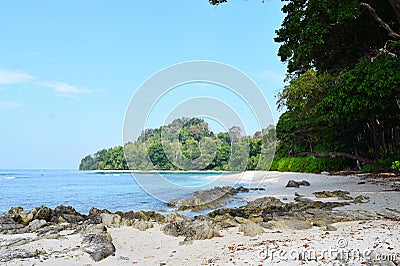 Neil`s Cove at Radhanagar Beach, Havelock Island, Andaman & Nicobar, India - Azure Water, Blue Sky, Stones and Greenery Stock Photo