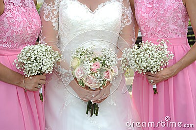 Bride and bridesmaids holding Bouquet Stock Photo