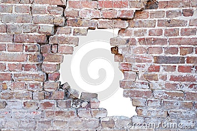 Photograph of a broken porous old brick wall with hole after accident Stock Photo