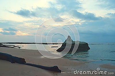 A Large Stone in Calm Sea Waters at Pristine Sandy Beach with Colors in Morning Cloudy Sky - Sitapur, Neil Island, Andaman, India Stock Photo