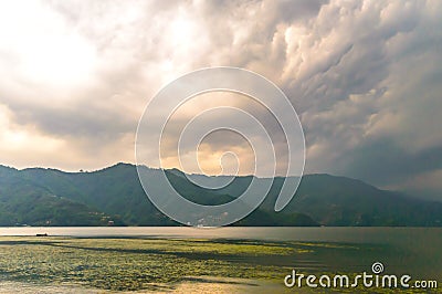 Photograph of cloud, lake, mountain and reflexion Near Pokhara Lake at Kathmandu Nepal. Snap in portrait, landscape, wide screen. Stock Photo