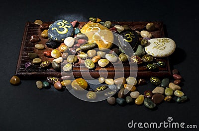 Colorful decorative stones painted with Om symbol Stock Photo