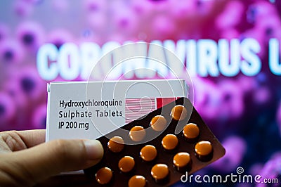 Hydroxychloroquine Sulphate tablets with coronavirus written in background Editorial Stock Photo