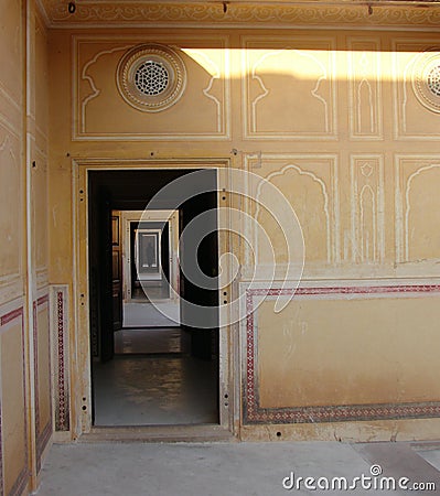 Locked in Home - A Long Corridor of Rectangular Doors with a Human Silhouette in Darkness Stock Photo