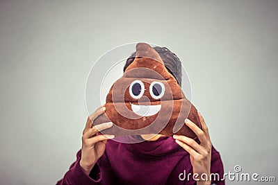 Man with poop emoji cushion Stock Photo