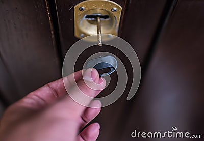 Broken house key stuck in door lock Stock Photo