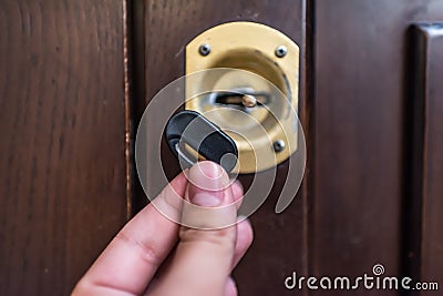 Broken house key stuck in door lock Stock Photo