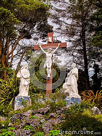 Roadside crucifix and holy statues Stock Photo