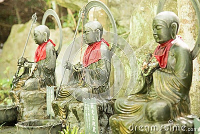 Photograph of three bronze statues of Buddha praying Stock Photo