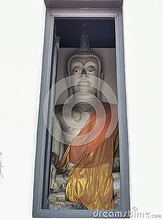 A photograph of view of statue of Buddha from an open door Stock Photo