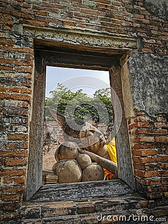 A Photograph of window view of statue of Reclining Buddha Stock Photo