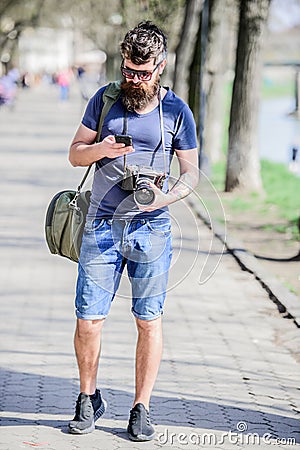 Photographer with beard and mustache. Tourist shooting photos. Content creator. Man bearded hipster photographer. Old Stock Photo