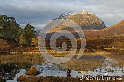 Photographer capturing the morning light at Loch Clair, Scotland Stock Photo