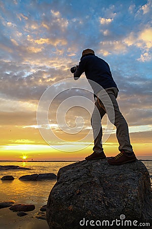 Photographer capturing sun rise Stock Photo