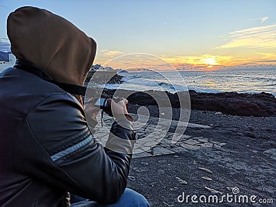 Photographer capturing a sunset Stock Photo