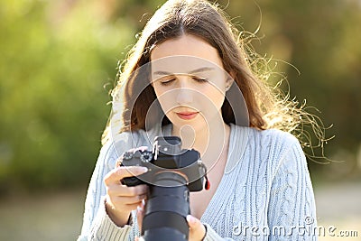 Photographer checks camera screen Stock Photo