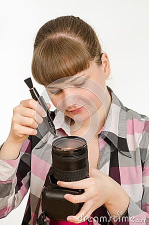 Photographer cleans front of lens on the camera Stock Photo