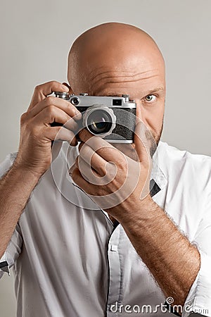 Photographer. Close up portrait of man holding vintage camera Stock Photo
