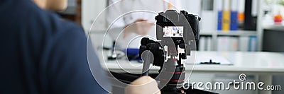 Photographer filming doctor on camera using tripod and slider closeup Stock Photo