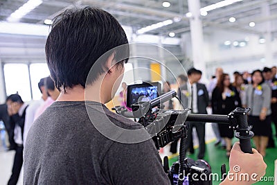 Photographer is filming a video for the company grand opening ceremony. Editorial Stock Photo