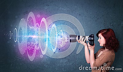 Photographer girl making photos with powerful light beam Stock Photo