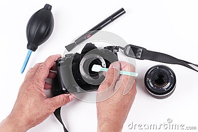 Photographer hand cleaning sensor of camera by using sensor swab Stock Photo