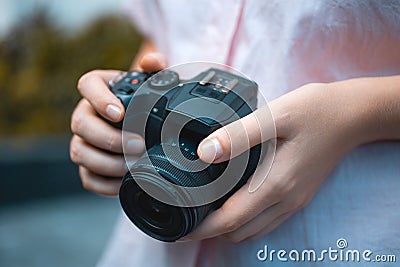 Photographer hands holding a digital camera, focusing and taking photos, macro closeup Stock Photo